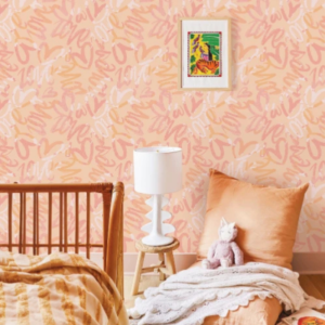 Letter Beam #2 peach lettering wallpaper with overlapping brush letters in a bedroom