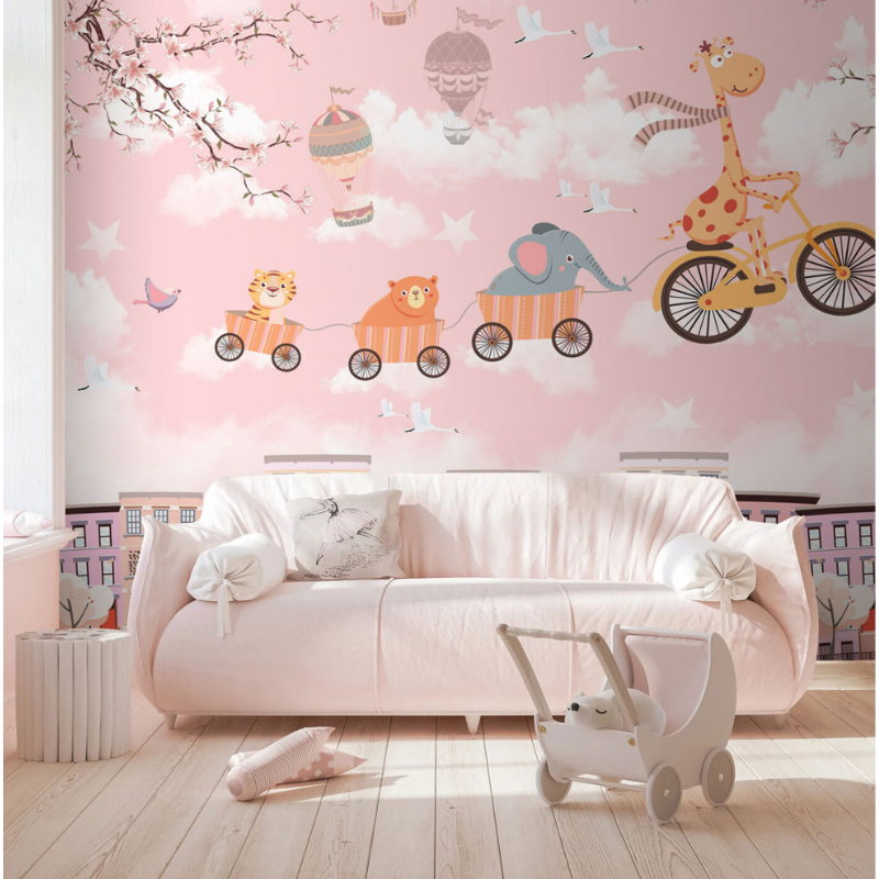 Pink Joyride wallpaper mural with a giraffe riding a bicycle pulling animals through pink clouds