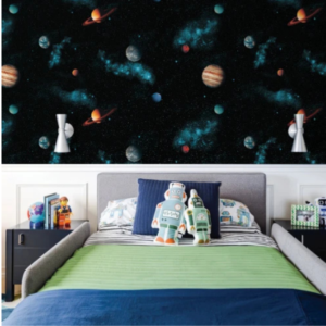 Cosmic galaxy wallpaper with planets, rockets and teal nebula on black in a boy’s bedroom